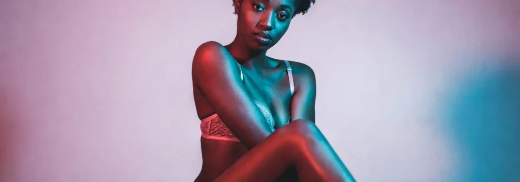 Attractive black cam model posing in lingerie